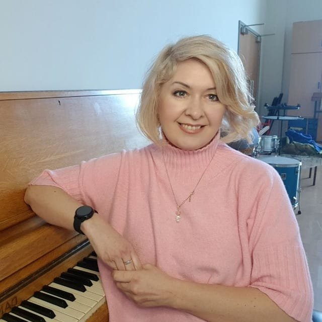 Natalia, piano teacher in Swindon, sitting at the piano