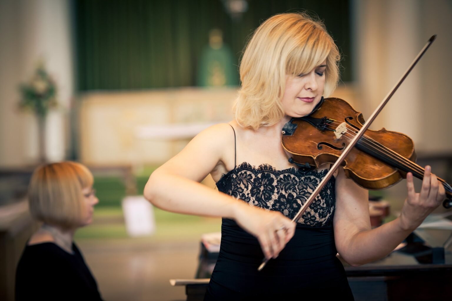 Natalia performing on the violin at a concert
